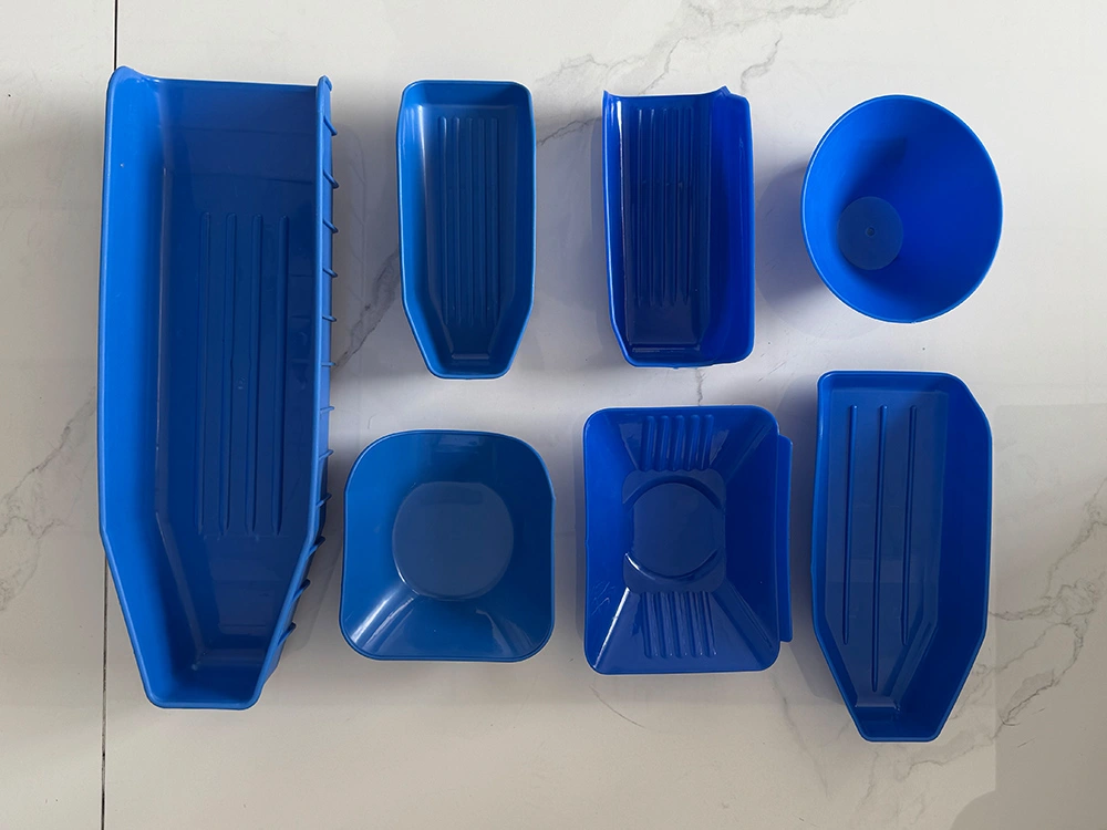 Multiple food processing trays in various shapes, ideal for sorting seafood, poultry, and fruits